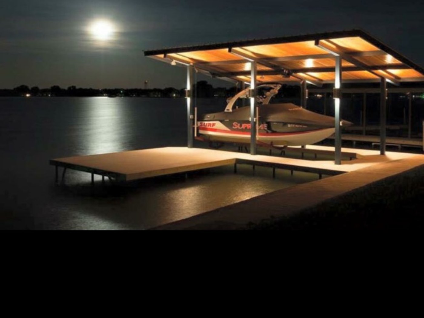 Covered boat dock and lift lighting at night installed by Longhorn Electric